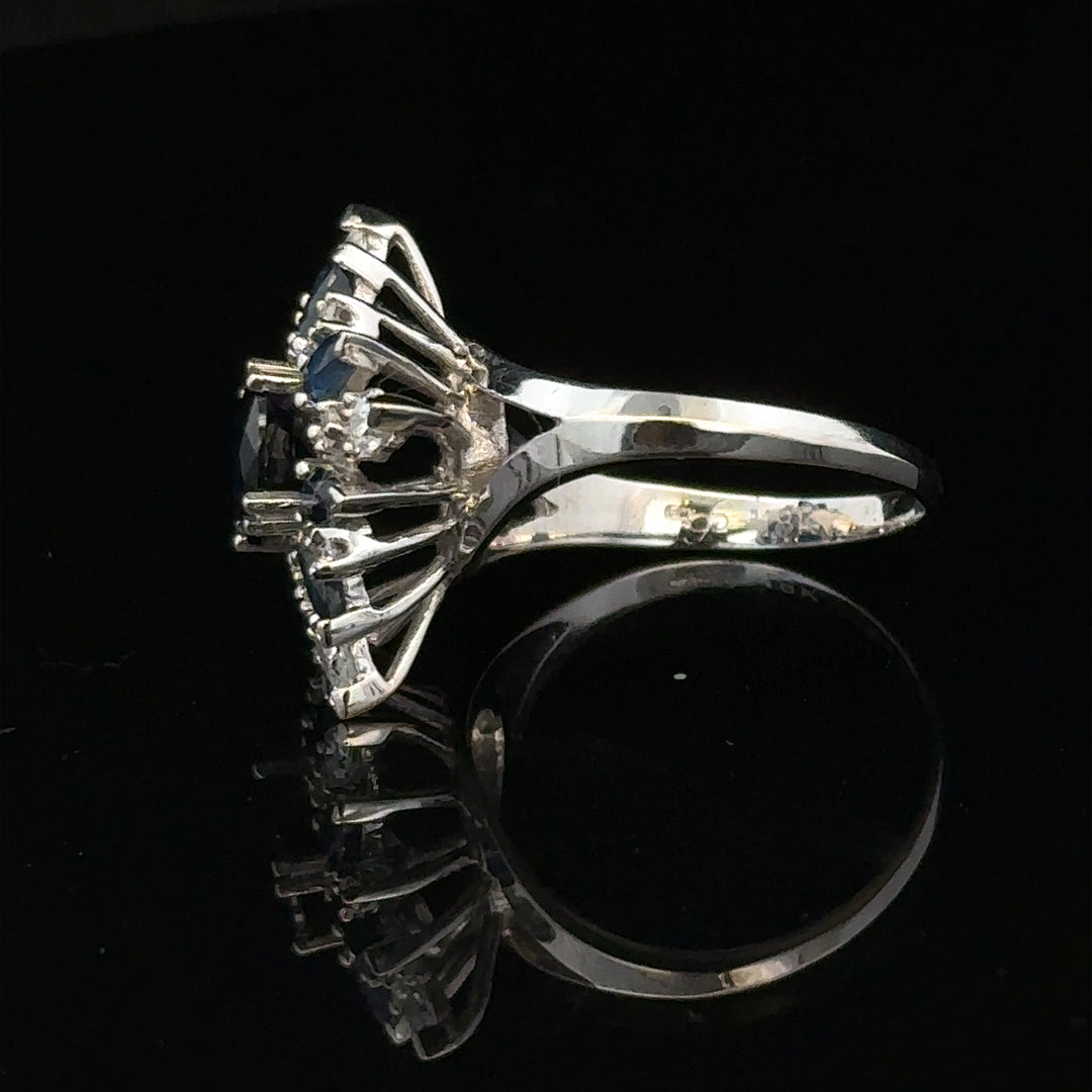 18ct white gold sapphire and diamond ring, size N1/2, featuring a central sapphire surrounded by sparkling diamonds.