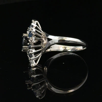 18ct white gold sapphire and diamond ring, size N1/2, featuring a central sapphire surrounded by sparkling diamonds.