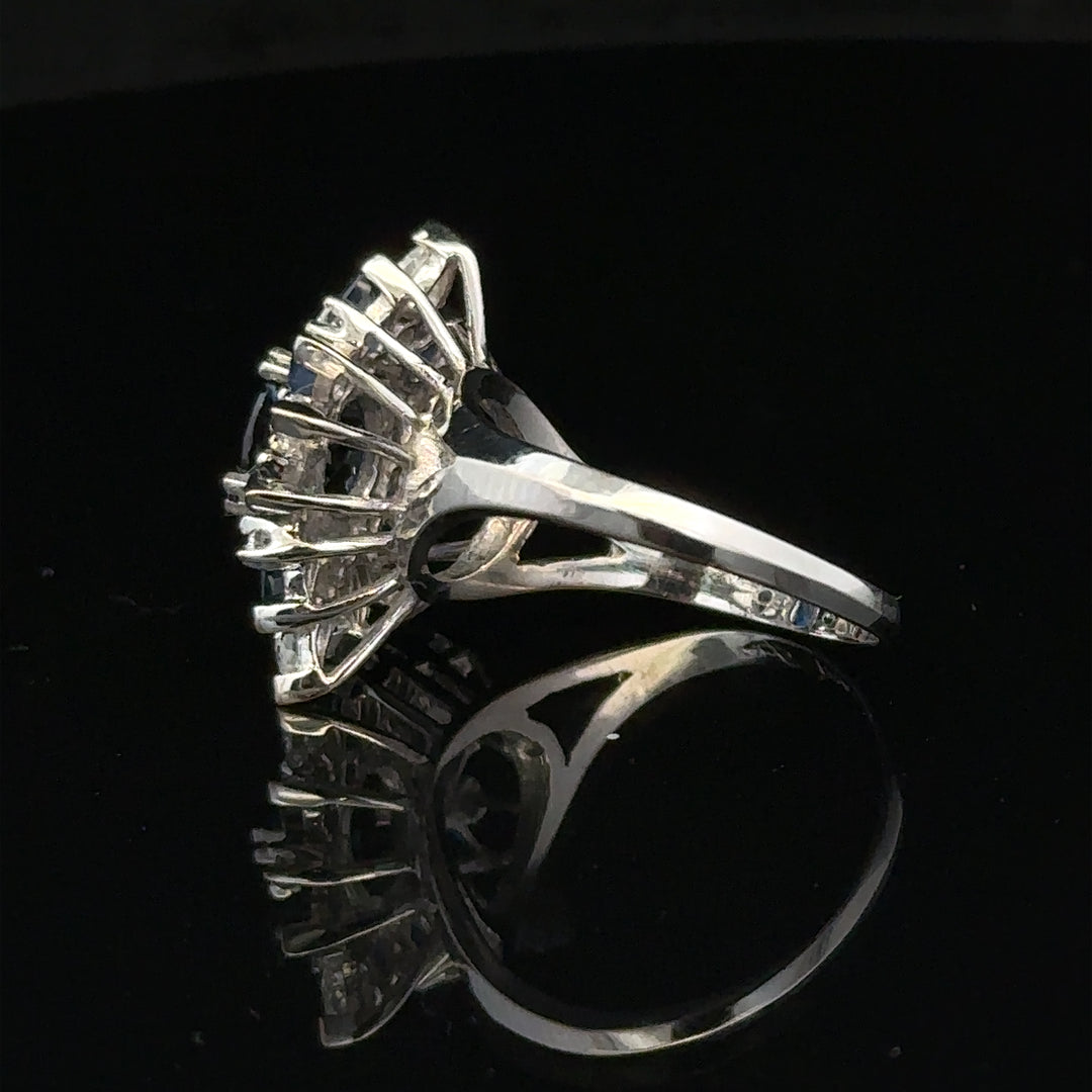 18ct white gold sapphire and diamond ring in size N1/2, featuring a central blue sapphire and sparkling diamonds.