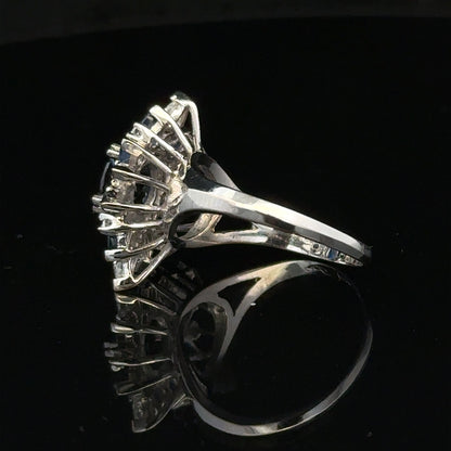 18ct white gold sapphire and diamond ring in size N1/2, featuring a central blue sapphire and sparkling diamonds.