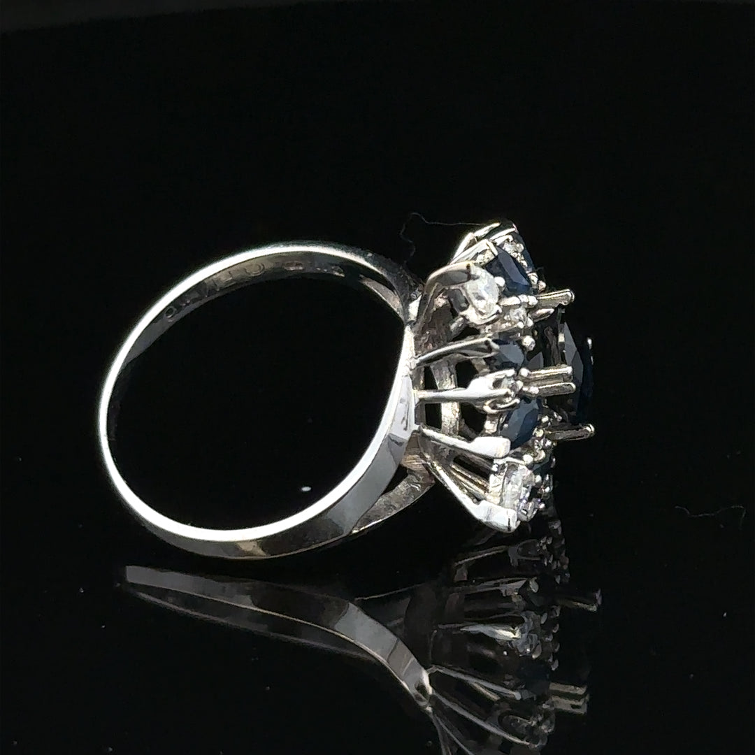 18ct white gold sapphire and diamond ring, size N1/2, featuring a central sapphire and sparkling diamonds.