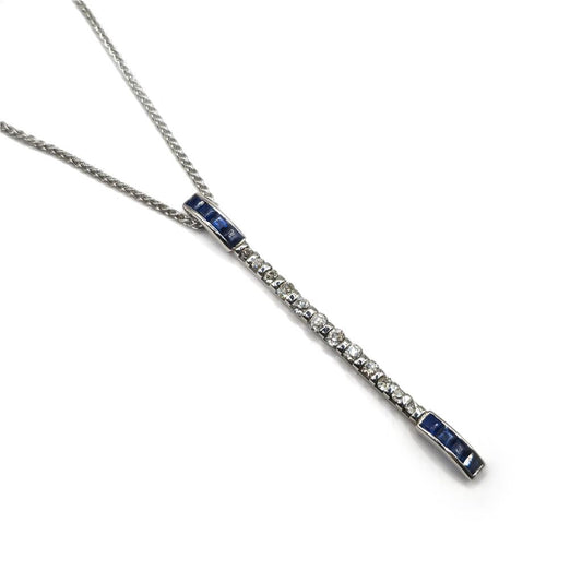 18ct white gold sapphire and diamond pendant on a white gold chain, featuring elegant gemstone and metal design.
