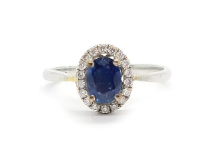 18ct white gold sapphire and diamond ring featuring a central sapphire gemstone surrounded by sparkling diamonds.