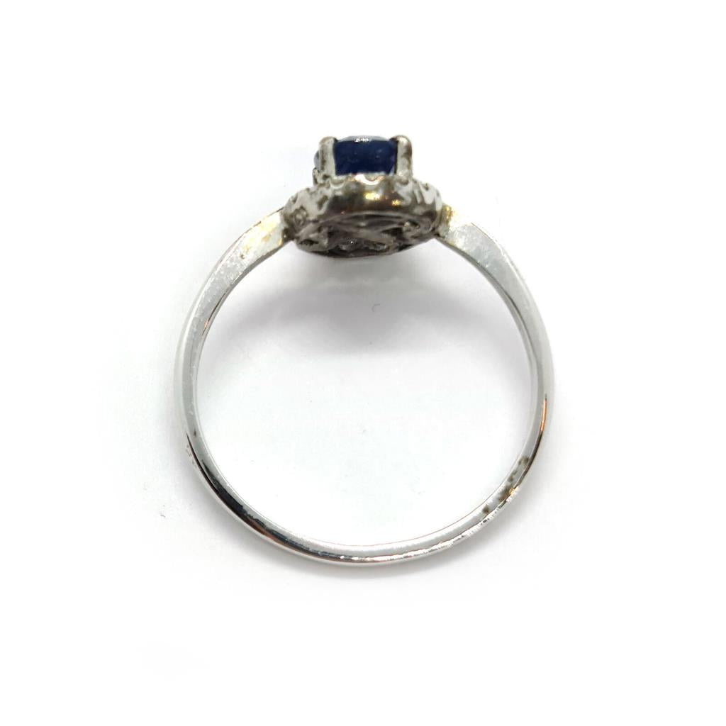 18ct white gold sapphire and diamond ring with a central blue sapphire and sparkling diamonds, elegant jewelry piece.