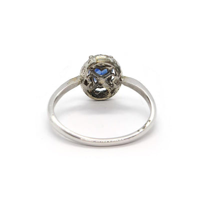 18ct white gold sapphire and diamond ring with a central blue sapphire and sparkling diamonds, elegant jewelry accessory.