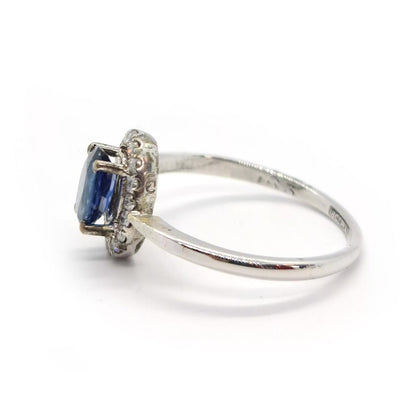 18ct white gold sapphire and diamond ring with a central blue sapphire and sparkling diamonds, elegant jewelry accessory.
