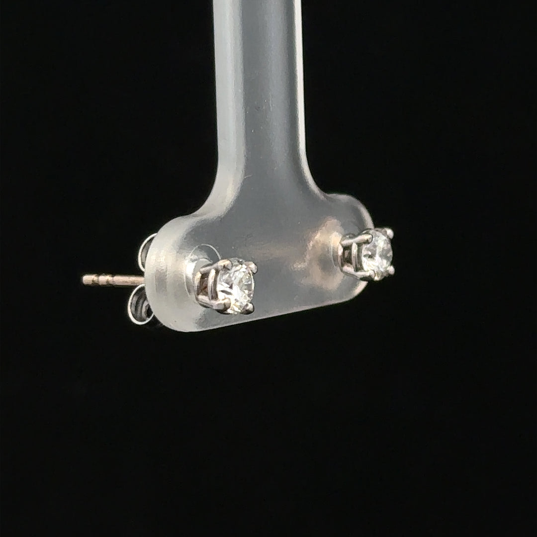 18ct white gold diamond stud earrings with 0.40 carats, featuring classic round-cut diamonds and a secure post back design.
