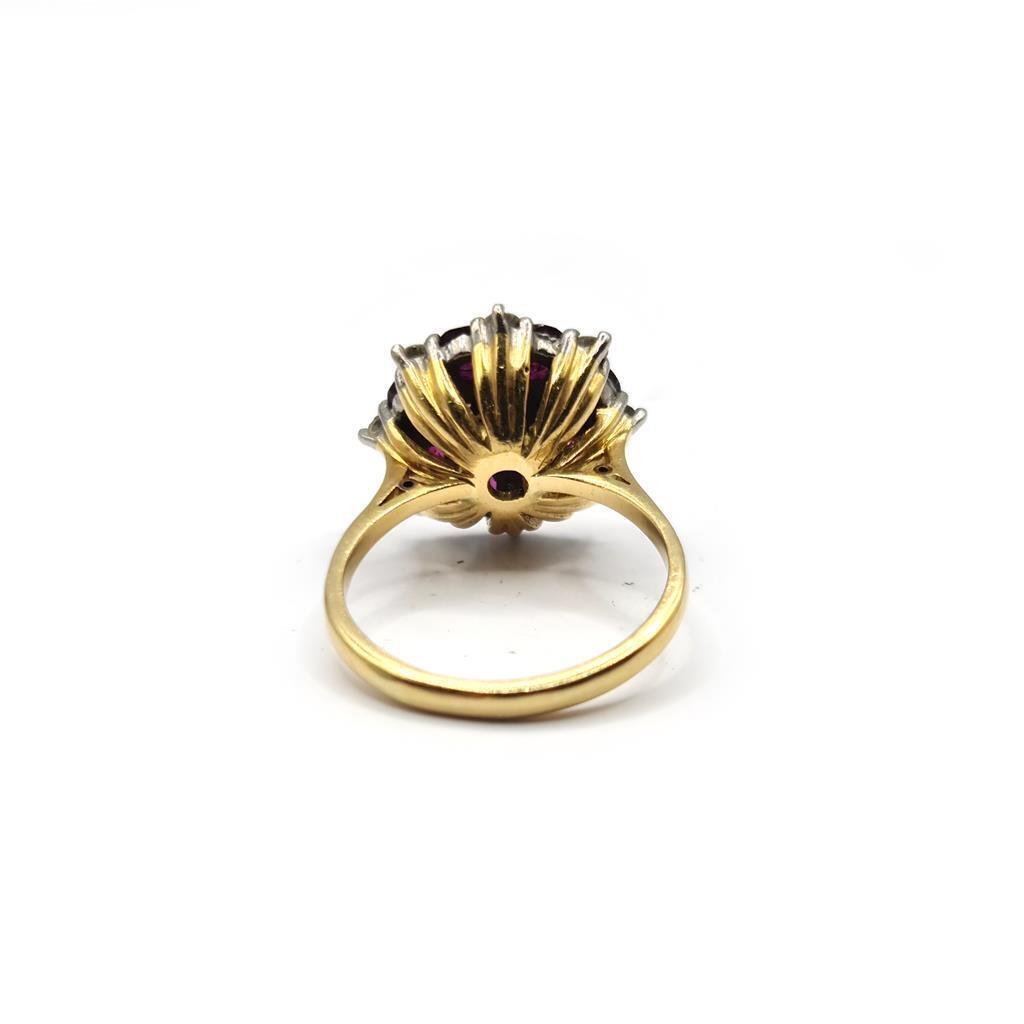 18ct yellow gold ring with a 0.25 carat ruby and 0.90 carat diamonds, featuring a classic design and sparkling gemstones.