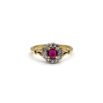 18ct yellow gold ring with a 0.33 carat ruby and 1/4 carat diamond, featuring a detailed band design.