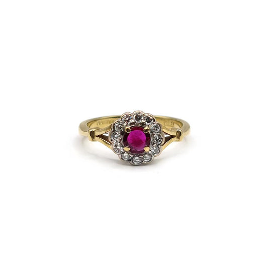 18ct yellow gold ring with a 0.33 carat ruby and 1/4 carat diamond, featuring a detailed band design.