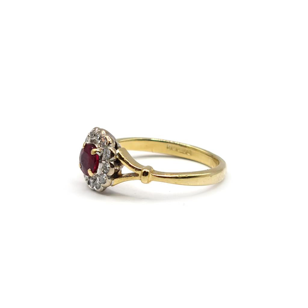 18ct yellow gold ring with a 0.33 carat ruby and 1/4 carat diamond accents, showcasing a elegant jewelry design.