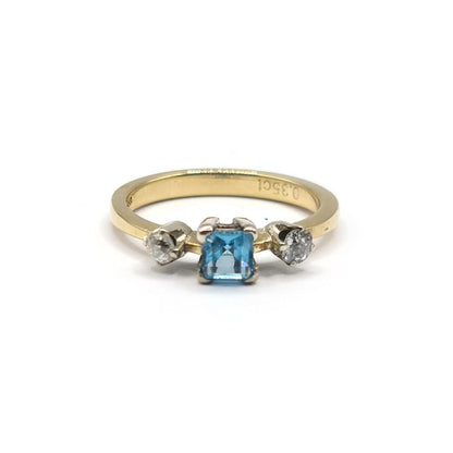 18ct yellow gold ring with a 0.35 carat topaz and 0.14 carat diamond accents, featuring a sleek design.