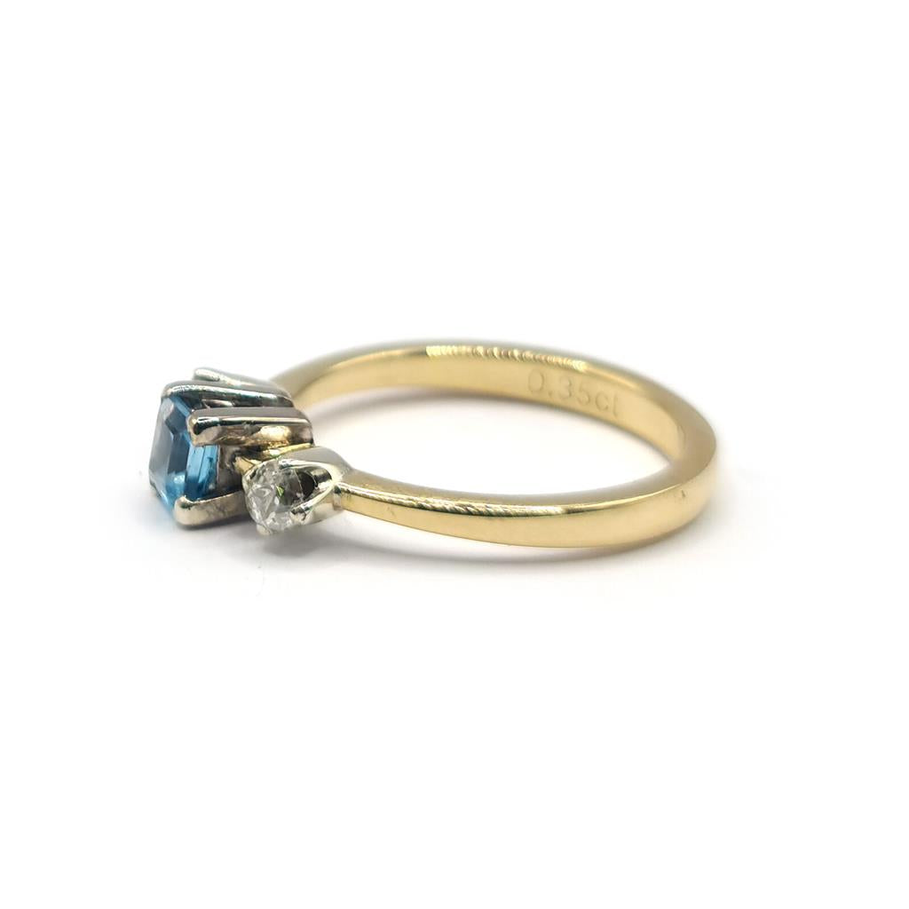 18ct yellow gold ring with 0.35ct topaz and 0.14ct diamond accents, featuring a sleek design and polished finish.
