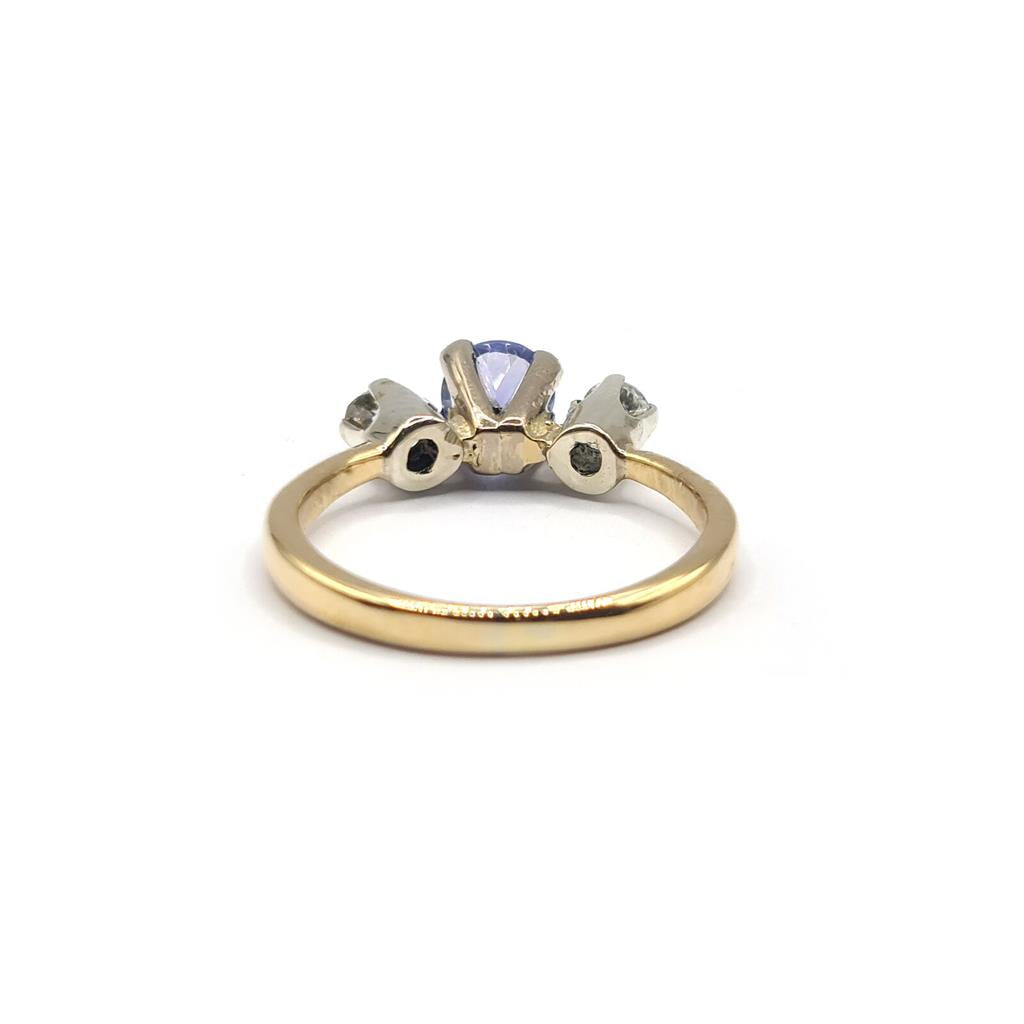18ct yellow gold ring with a 0.40 carat tanzanite and 0.20 carat diamond accents, featuring a sleek design and sparkling gemstones.