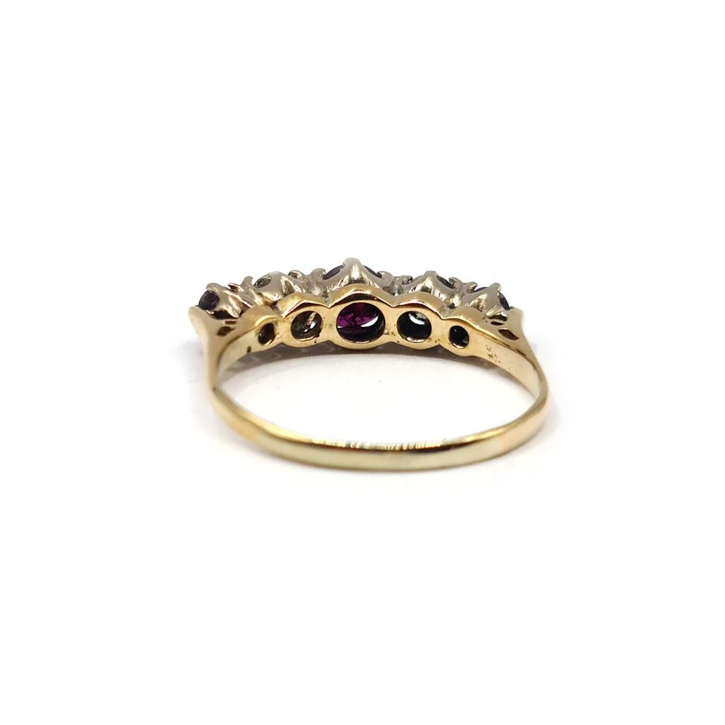 18ct yellow gold ring with 0.85 carat ruby and 0.44 carat diamond accents, featuring a classic jewelry design.
