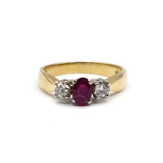 18ct yellow gold ring with a 1/2 carat ruby and 0.30 carat diamonds, showcasing a elegant jewelry design.