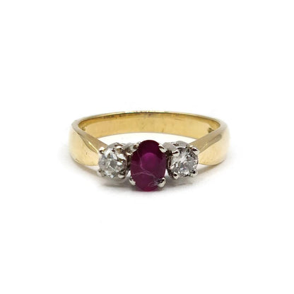 18ct yellow gold ring with a 1/2 carat ruby and 0.30 carat diamonds, featuring a classic and elegant design.