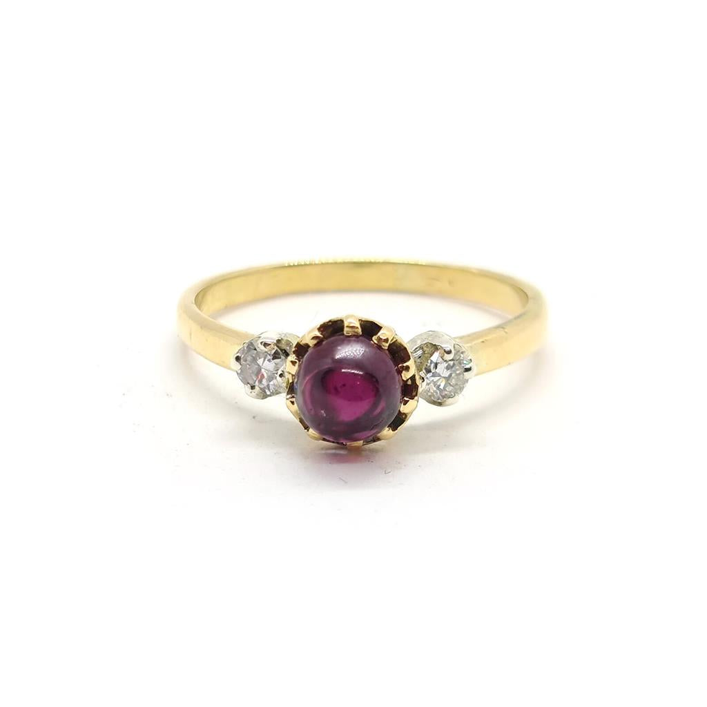 18ct yellow gold ring with a 1.45 carat garnet and 0.30 carat diamond accents, featuring a classic jewelry design.