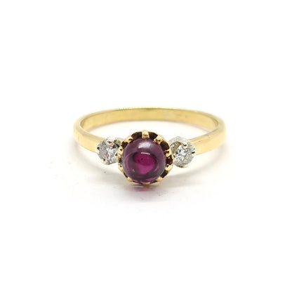 18ct yellow gold ring with a 1.45 carat garnet and 0.30 carat diamond accents, featuring a classic jewelry design.