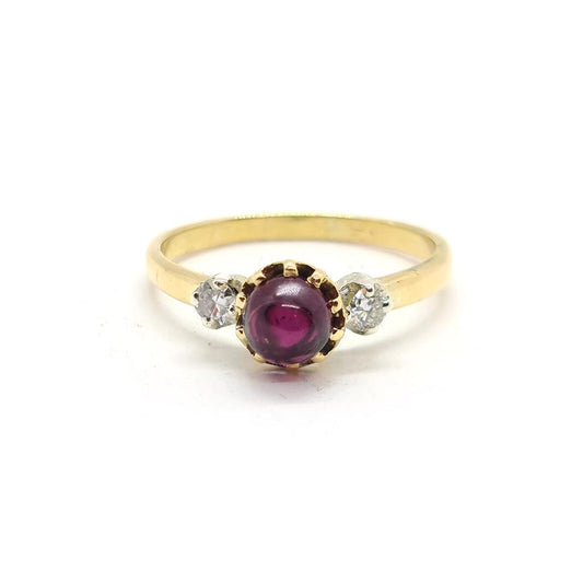 18ct yellow gold ring with a 1.45 carat garnet and 0.30 carat diamond accents, featuring a classic jewelry design.