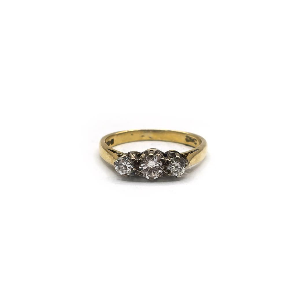 18ct yellow gold ring with three diamonds in size K, elegant unbranded jewelry featuring sparkling gemstones.
