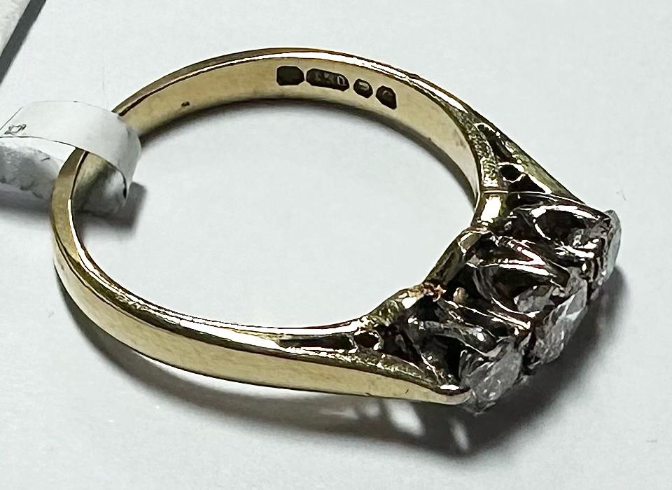 18ct yellow gold ring with three diamonds, size K, featuring a classic design and sparkling gemstone accents.