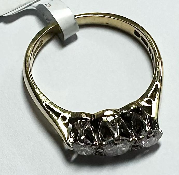 18ct yellow gold ring with three diamonds, size K, featuring elegant design and sparkling gemstones.