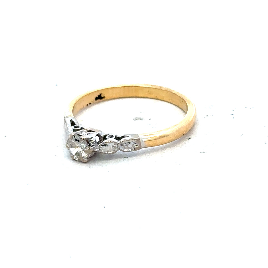 18ct yellow gold and platinum diamond ring, size M, showcasing a sleek band with sparkling diamonds and a polished finish.