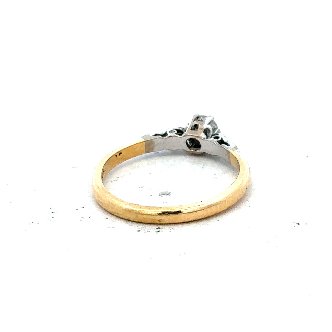 18ct yellow gold and platinum diamond ring, size M, featuring a detailed band with sparkling diamonds.