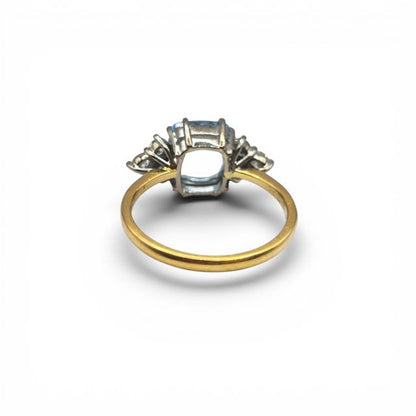 18ct yellow gold aquamarine and diamond ring featuring a central aquamarine gemstone and accent diamonds, elegant jewelry piece.