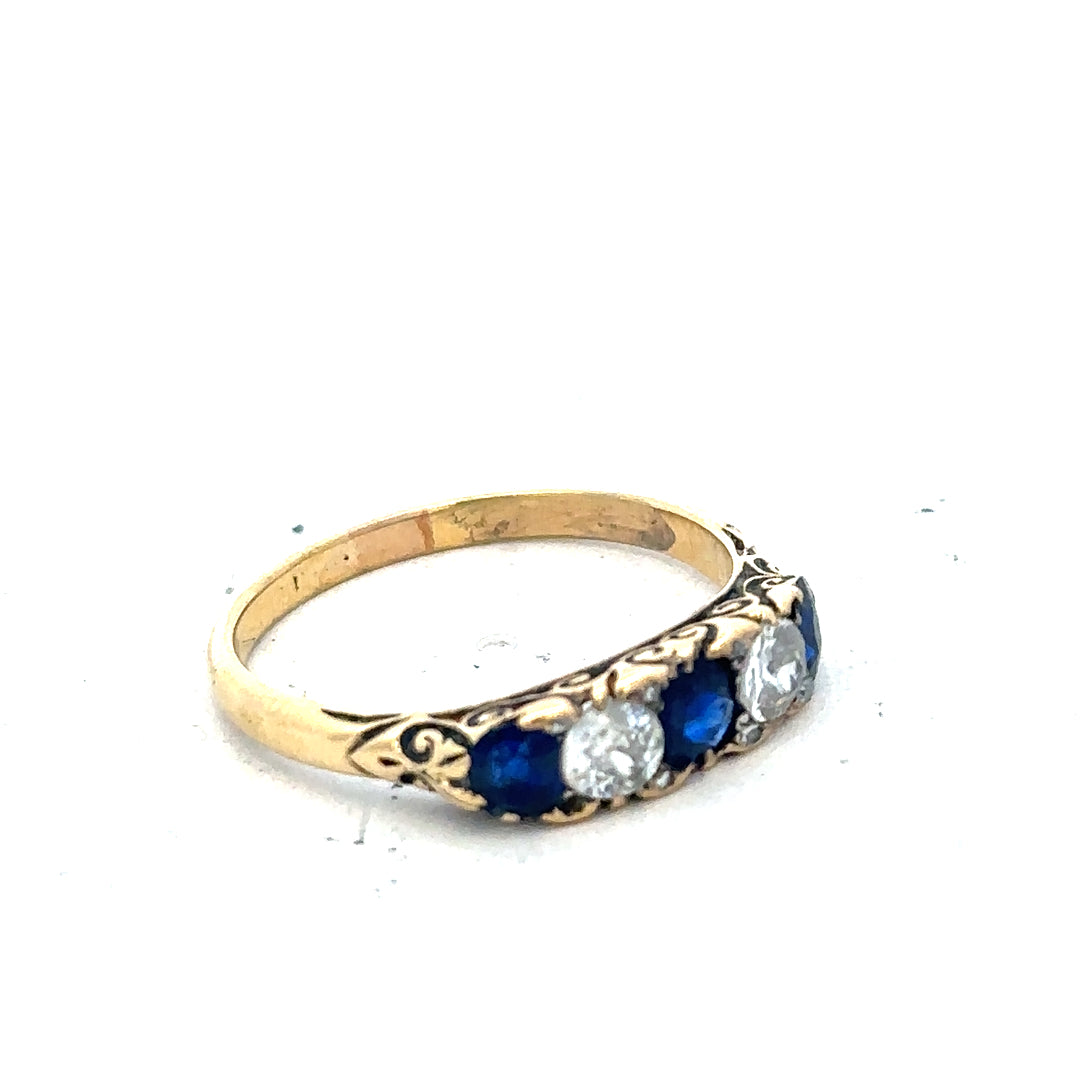 18ct yellow gold diamond and sapphire ring in size O 1/2, featuring a detailed design and sparkling gemstones.
