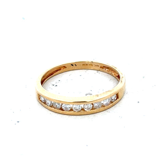 18ct yellow gold diamond half eternity ring with a continuous row of sparkling diamonds on a sleek band.