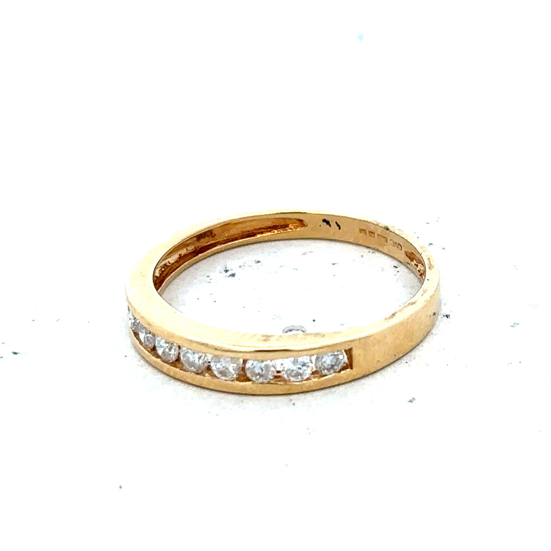 18ct yellow gold diamond half eternity ring with a continuous row of sparkling diamonds on a sleek band.
