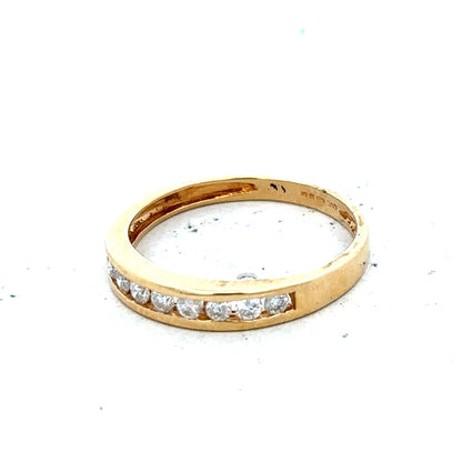 18ct yellow gold diamond half eternity ring with a continuous row of sparkling diamonds on a sleek band.