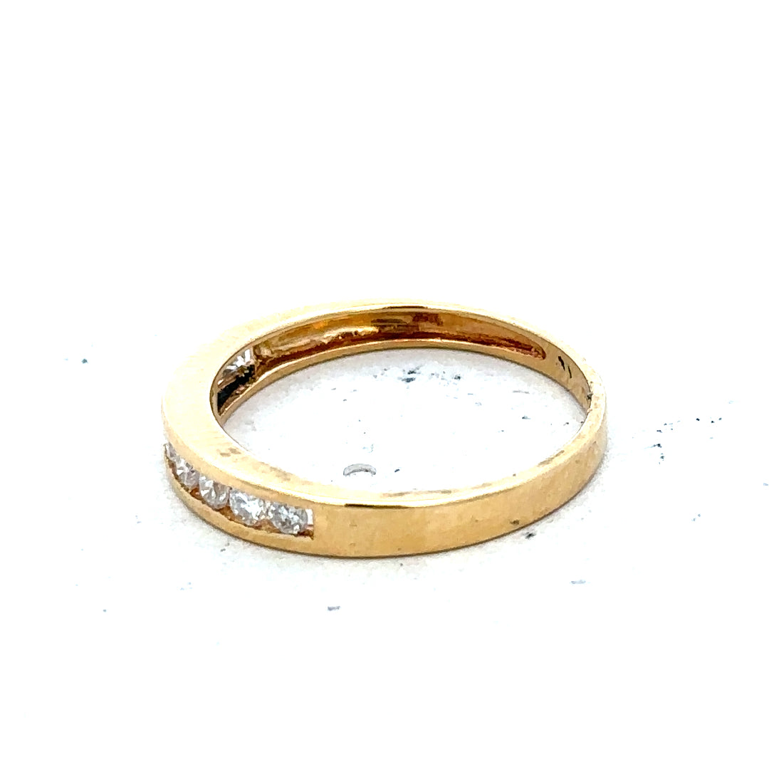 18ct yellow gold diamond half eternity ring featuring a continuous row of sparkling diamonds in a sleek gold band.