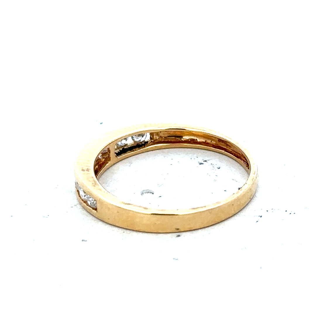 18ct yellow gold diamond half eternity ring with sparkling gemstones and a sleek, elegant design.