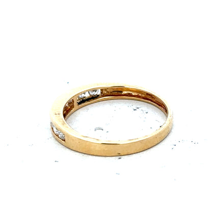 18ct yellow gold diamond half eternity ring with sparkling gemstones and a sleek, elegant design.