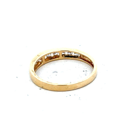 18ct yellow gold diamond half eternity ring with a continuous row of sparkling diamonds on a sleek band.