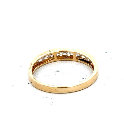 18ct yellow gold diamond half eternity ring with a row of sparkling diamonds in a sleek, elegant design.