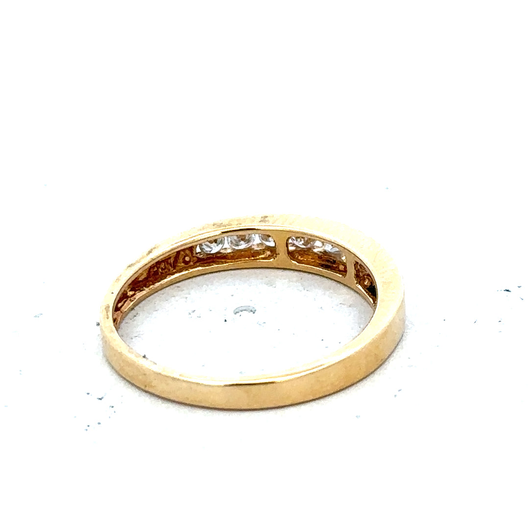 18ct yellow gold diamond half eternity ring with sparkling diamonds set around the band, showcasing elegant jewelry craftsmanship.