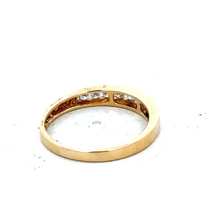 18ct yellow gold diamond half eternity ring with sparkling diamonds set around the band, showcasing elegant jewelry craftsmanship.