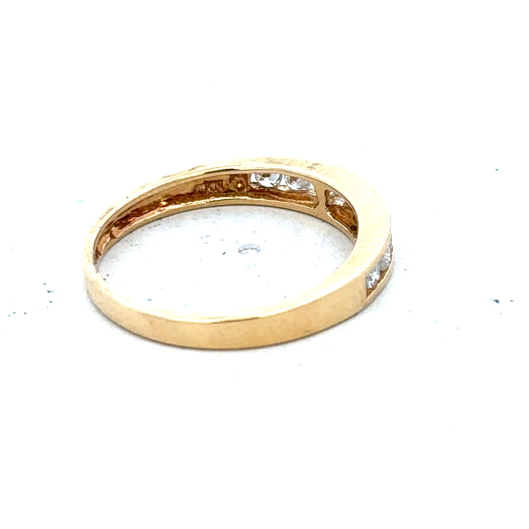 18ct yellow gold diamond half eternity ring with a continuous row of sparkling diamonds around the band.