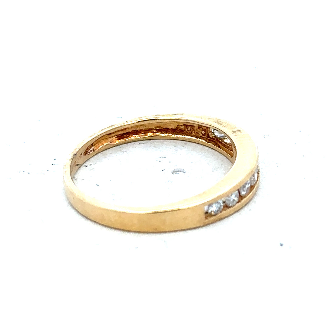 18ct yellow gold diamond half eternity ring featuring a row of sparkling diamonds around the band.