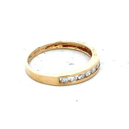 18ct yellow gold diamond half eternity ring with sparkling stones set around the band, showcasing elegant jewelry craftsmanship.