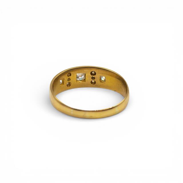 18ct yellow gold diamond ring with a sparkling central diamond and elegant band, unbranded jewelry piece.