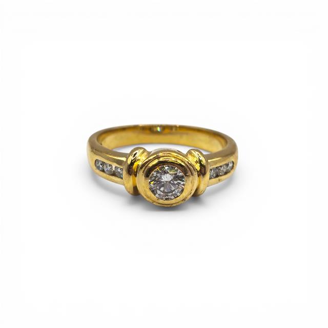 18ct yellow gold diamond ring with sparkling diamonds, showcasing a luxurious and elegant design.