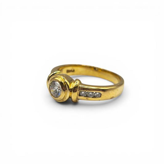 18ct yellow gold diamond ring with sparkling diamonds, featuring a classic design and polished finish.