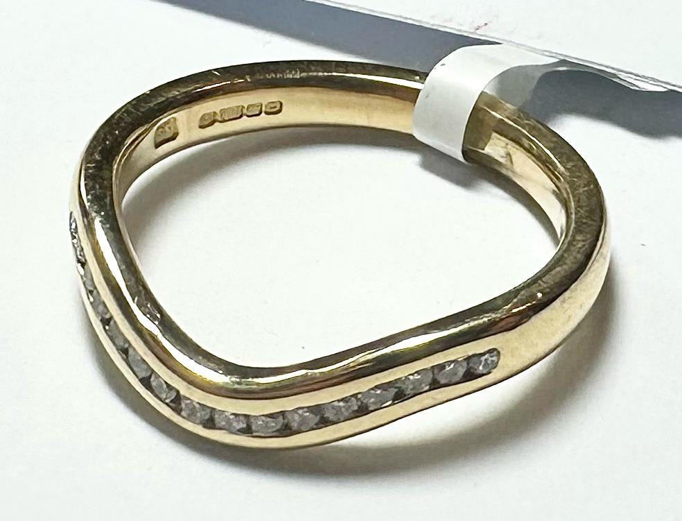 18ct yellow gold diamond ring in size K with sparkling diamonds, unbranded, showcasing a luxurious jewelry design.