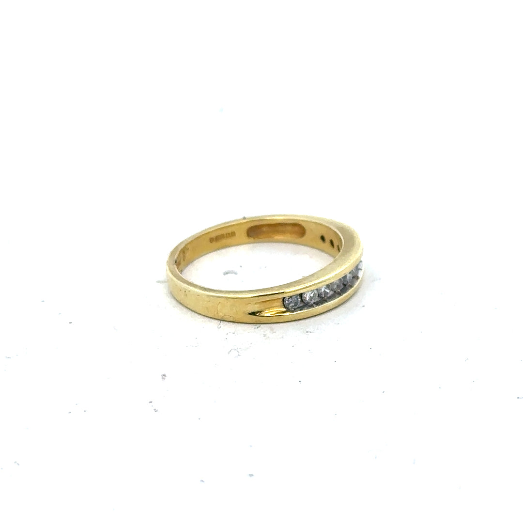 18ct yellow gold diamond ring in size L with sparkling diamonds, showcased on a neutral background.
