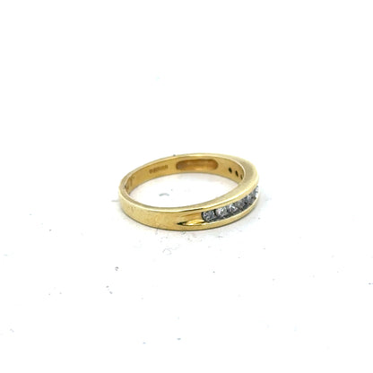 18ct yellow gold diamond ring in size L with sparkling diamonds, showcased on a neutral background.